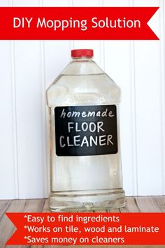 a bottle of homemade floor cleaner sitting on top of a wooden table