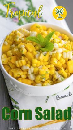 corn salad in a white bowl on top of a green and white napkin with the title tropical corn salad