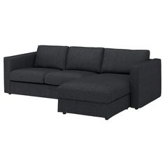 a black couch sitting on top of a white floor