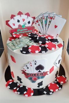 a cake decorated with playing cards and poker chips