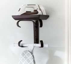 an ironing board and iron on the wall