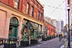 an empty city street with people walking on the sidewalk