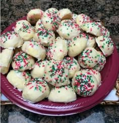 a plate full of cookies with sprinkles on it sitting on a table