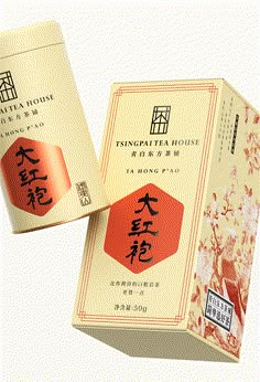 an open box of tea with chinese writing on the front and back side, sitting next to it's packaging