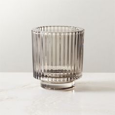 a clear glass vase sitting on top of a white table