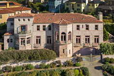 an aerial view of a large house with many windows