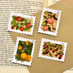 four stamps with fruit on them sitting on top of an open book