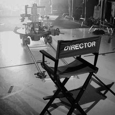 a director's chair sits in the middle of a stage with other equipment behind it