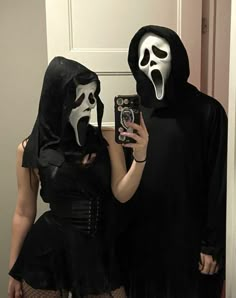 two people dressed up in halloween costumes taking a selfie