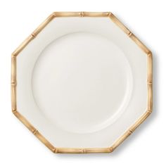 an empty white plate with bamboo decoration on it