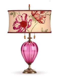 a pink lamp with a flower shade on it