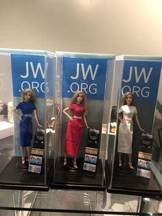 three barbie dolls are displayed on display in plastic cases with the names jw orc