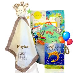 a stuffed giraffe is next to some books and balloons