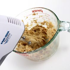 a blender filled with food on top of a white table