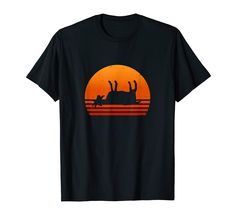 a black t - shirt with an image of a rhinoceros in the sunset