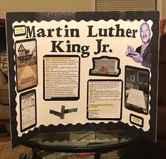 the martin luther king jr poster is on display in front of a table full of books