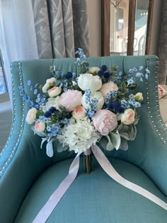 a bouquet of flowers sitting on top of a blue chair