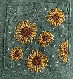 the back pocket of a pair of jeans with embroidered flowers on it