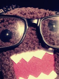 a teddy bear with glasses on it's face