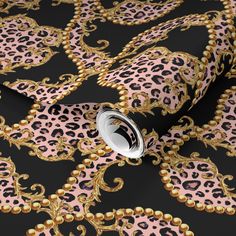 pink and black leopard print wallpaper with gold trimmings on a black background