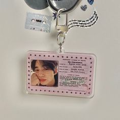 a keychain with a photo on it and some tags attached to the back