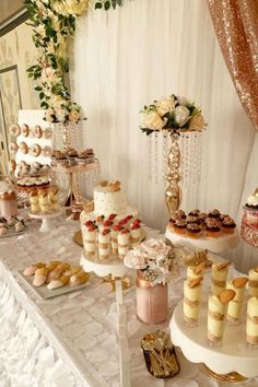 a table topped with lots of cakes and desserts