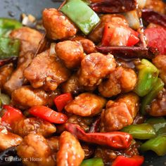 chicken and peppers stir fry in a wok