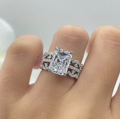 a woman's hand with a ring on it and a diamond in the middle