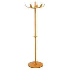 a wooden coat stand with two hooks on it's sides and an umbrella holder in the middle