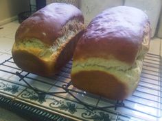 two loaves of bread sitting on top of a cooling rack