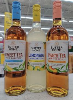 two bottles of lemonade sit next to each other on a counter in a store