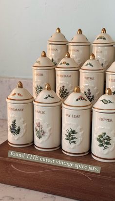 a group of ceramic canisters sitting on top of a table