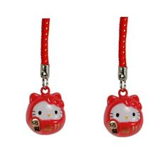 two red hello kitty charms hanging from strings