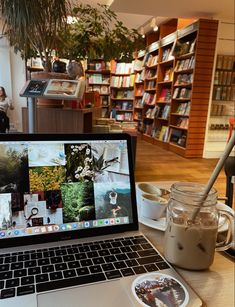 an open laptop computer sitting on top of a wooden table next to a cup of coffee