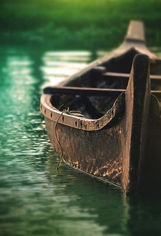 a boat is sitting in the water with its oar extended to it's side