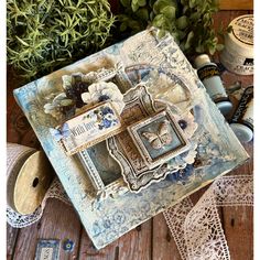 a close up of a box on a table with flowers and other items around it