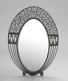 an ornately designed mirror is shown against a white background, with wheels on each side