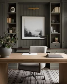 a home office with built in bookshelves and desk