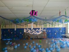 a room filled with balloons and streamers in the shape of an ocean theme for a birthday party