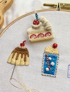 three hand embroidered cakes on a hoop