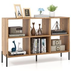 a book shelf with books, vases and pictures on it