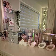 a counter top with various items on it and a window in the backround