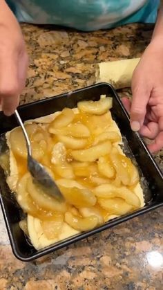 a person cutting up some food on top of a pan