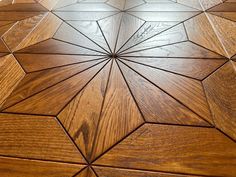 a wooden floor with an intricate design on it's surface and wood graining