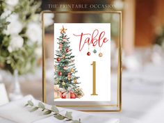 a table with a christmas tree on it and the words table 1 in gold frame