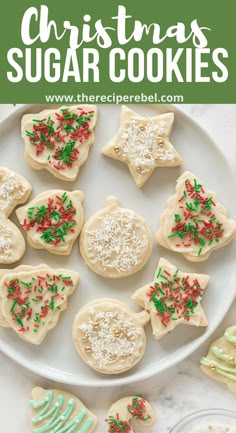 christmas sugar cookies with sprinkles on a white plate