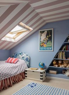 a child's bedroom with blue walls, striped carpet and an atticed ceiling