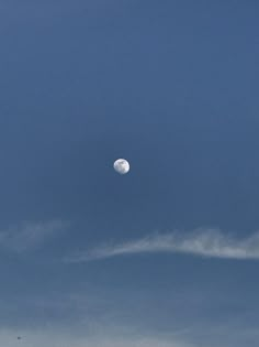 the moon is in the blue sky with clouds