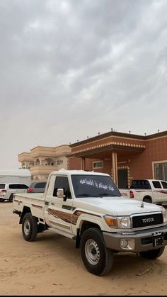 a white truck parked in front of a building