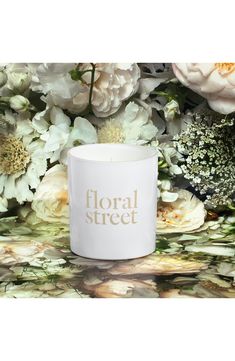 floral street candle holder in white with gold foil lettering on the front and bottom, surrounded by flowers